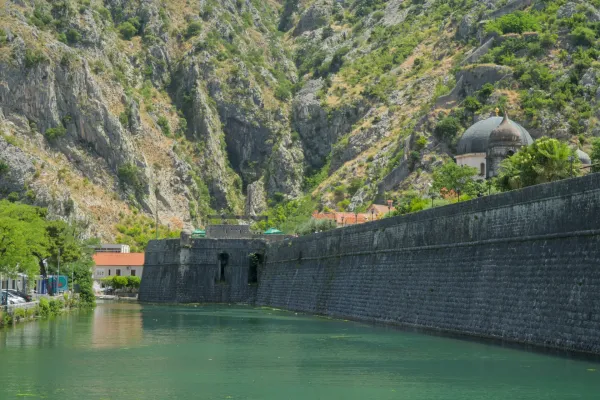 Kotor fortress wall with steep mountains in the background