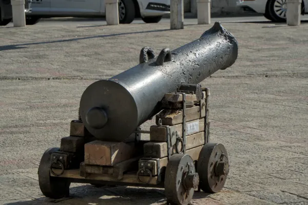 A historical cannon on wheels guards the entrance to the Old Town of Kotor, Montenegro.