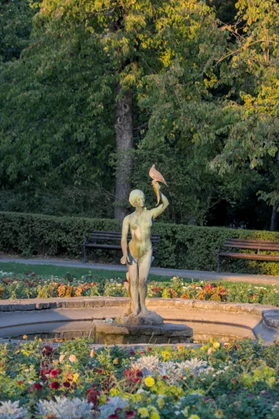 Sculpture d'une fille avec une corne d'abondance sur laquelle est perché un oiseau, dans un parc de Novi Sad, Serbie.