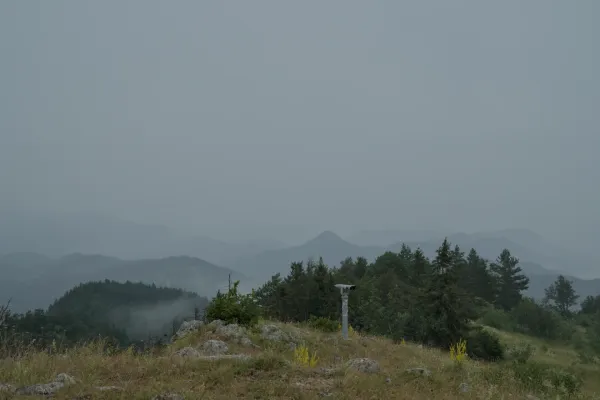Observation deck on the summit of Janiči, view of the Serbian side with foggy mountains.