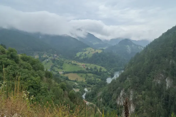 Landscape image with a view of Spajić Lake and the surrounding green mountains in Tara National Park, Serbia.