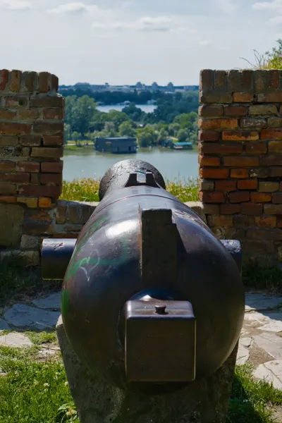 Kalemegdan cannon against the backdrop of the Sava River in Belgrade, Serbia, at sunset.