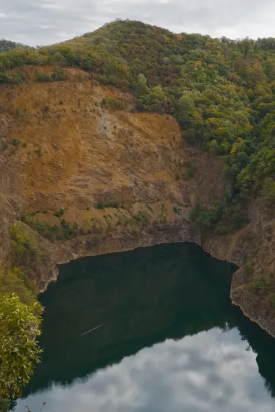 Ledinačko Lake under dense clouds amidst steep rocks, Serbia.