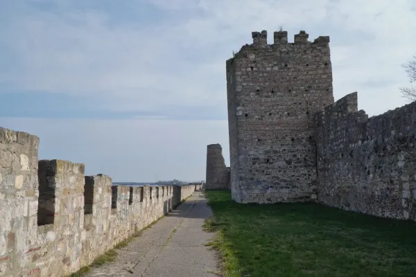 The stone walls and towers of Smederevo Fortress in Serbia, with a walkway winding along the wall.