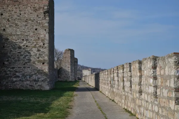 A path winds through the fortress walls of Smederevo, Serbia, with stone towers and a city in the background.