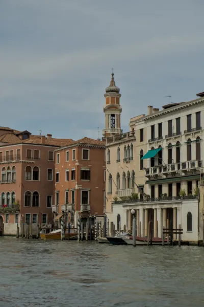 Fotografie von Gebäuden am Canal Grande in Venedig, Italien, mit einem markanten Kirchturm und Booten im Wasser.