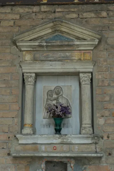 Religijska skulptura Bogorodice sa Hristom i cvećem u kamenoj niši, pogodna za zidni dekor.