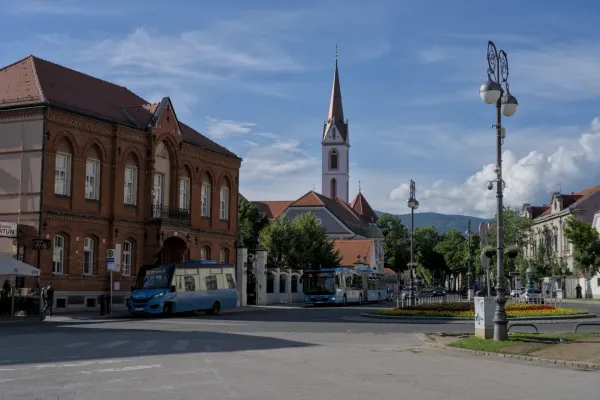 Una piazza di Zagabria, Croazia, con una chiesa, autobus e architettura.