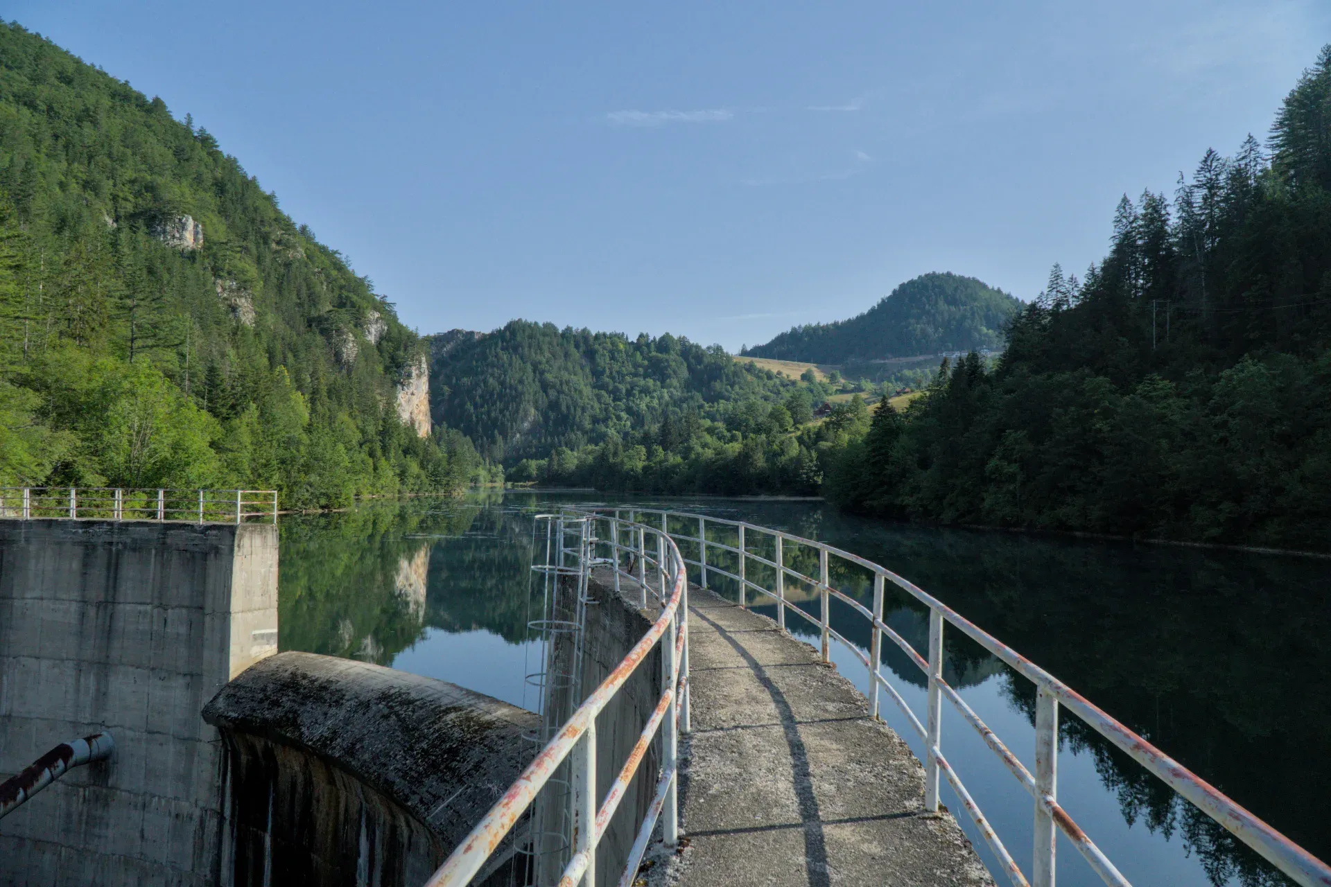 The Spajiči Dam in Zaovine, Serbia, featuring calm waters and green mountains, ideal for gallery art.