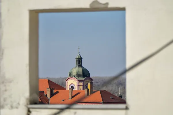 Architectural view of the Gymnasium dome in Sremski Karlovci, Serbia, seen through a framed opening.