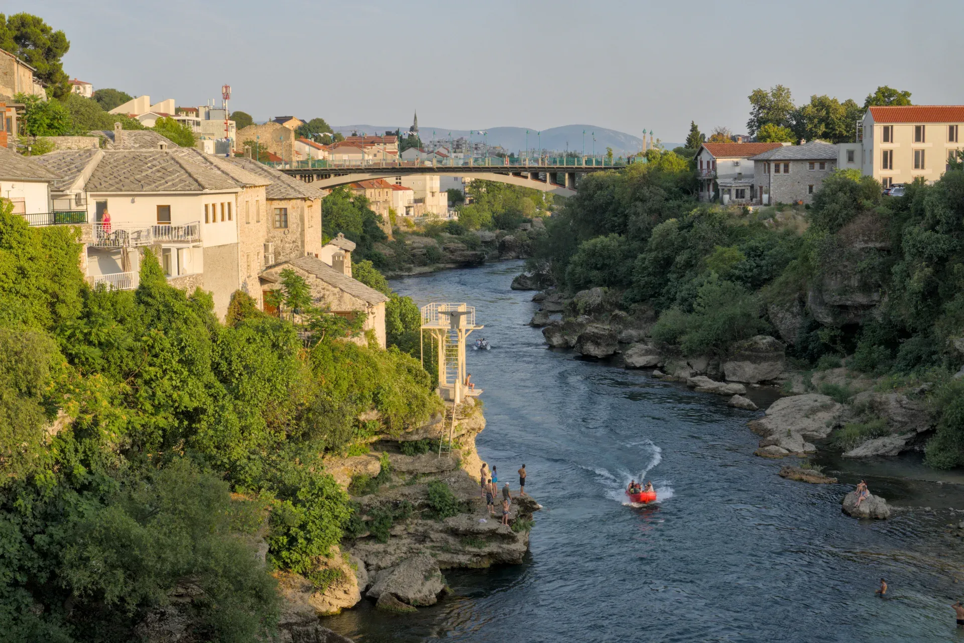 Historic Mostar cityscape with the Neretva River during the "predzakatni chas" (pre-twilight hour).