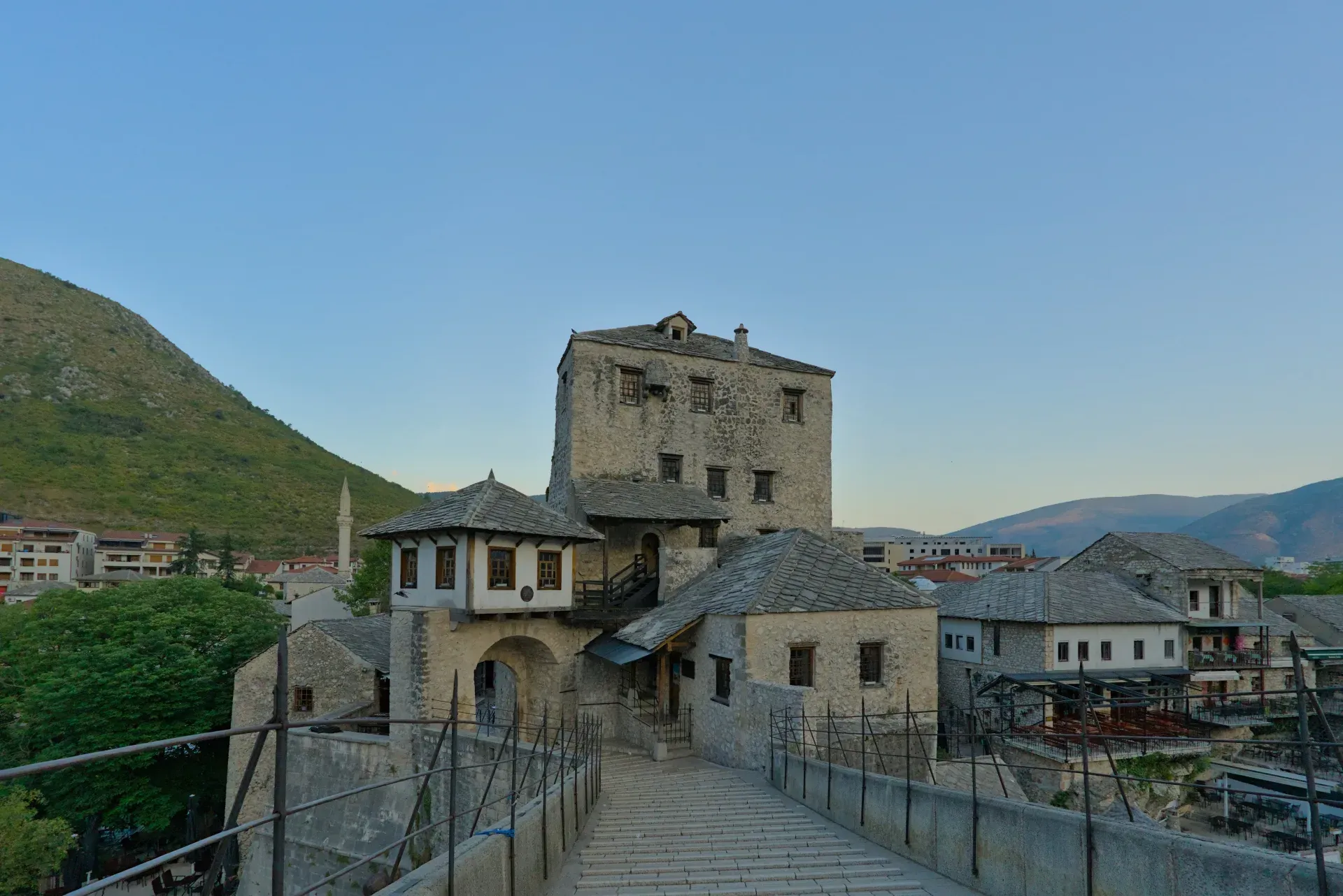 View of the Stari Most and towers in Mostar, Bosnia and Herzegovina, with a clear sky in the background.