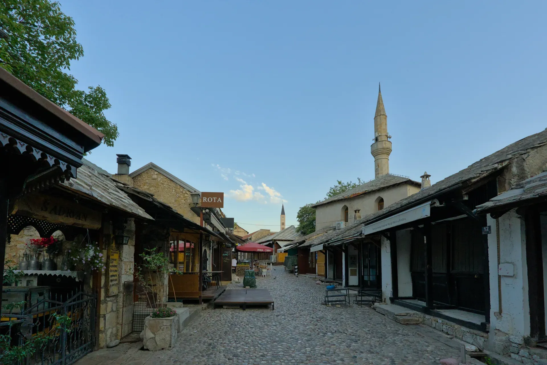 Landscape fine art photograph of Mostar Old Town in the early morning, featuring cobblestone streets and historic architecture.