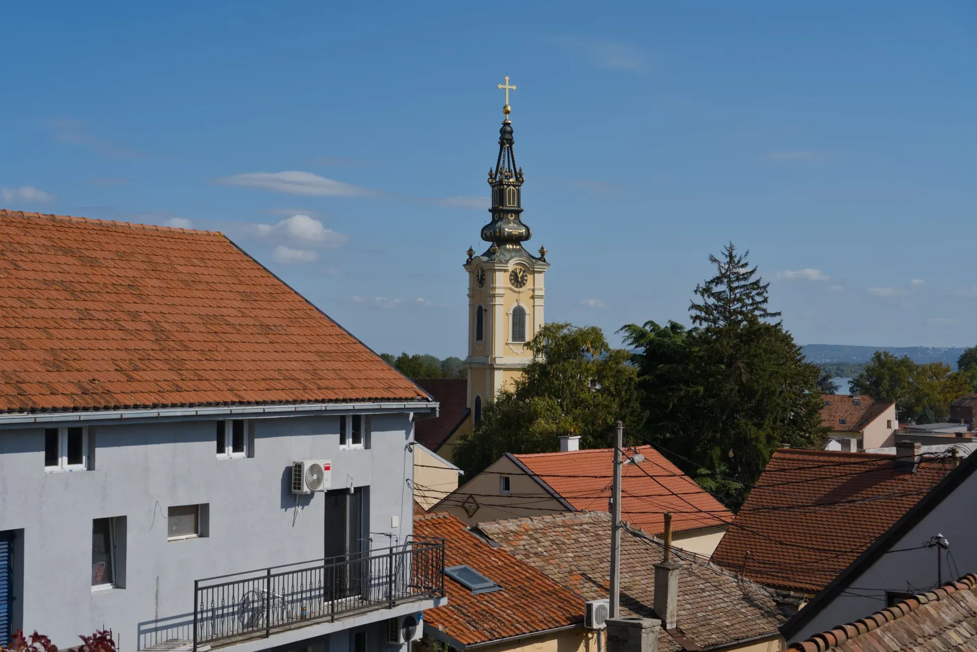 View of Zemun, Belgrade, with a bell tower and terracotta roofs of houses.