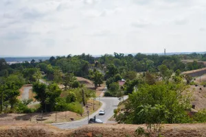 Panoramic view of the green landscape with winding paths and a distant cityscape from Petrovaradin Fortress in Novi Sad, Serbia.