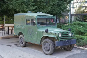 A vintage green Brauhaus Craft Beer van with the slogan 'Wish You Were Beer' parked on a street in Novi Sad, Serbia.